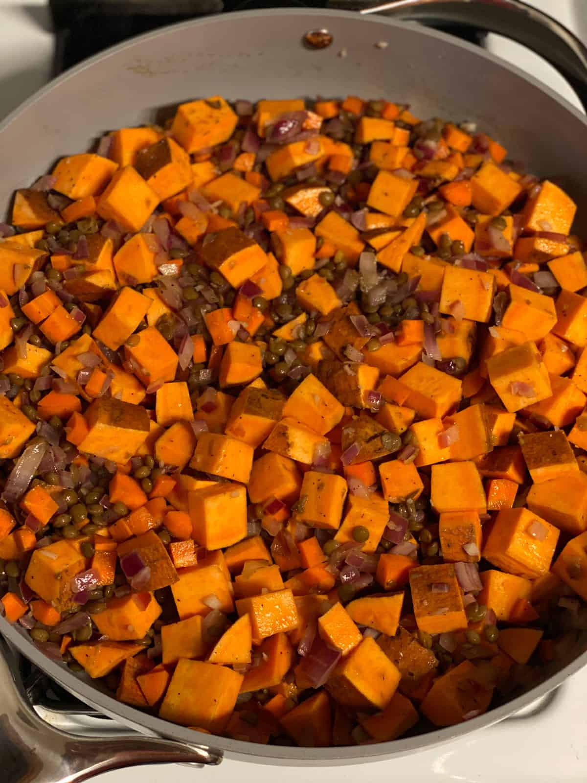 process shot of mixing ingredients together in pan