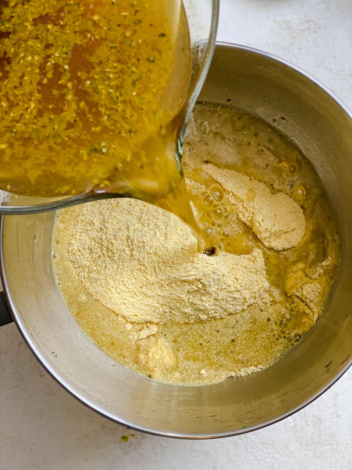 process shot of pouring vegetable broth mixture into pan