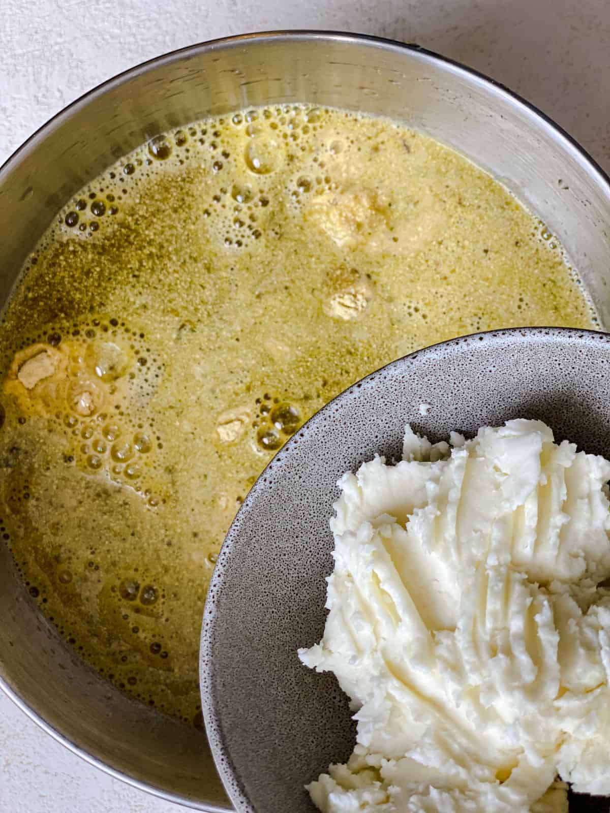 process shot of adding shortening to veggie broth mixture