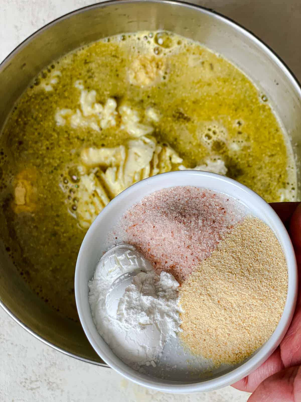 process shot of adding spices to veggie broth mixture