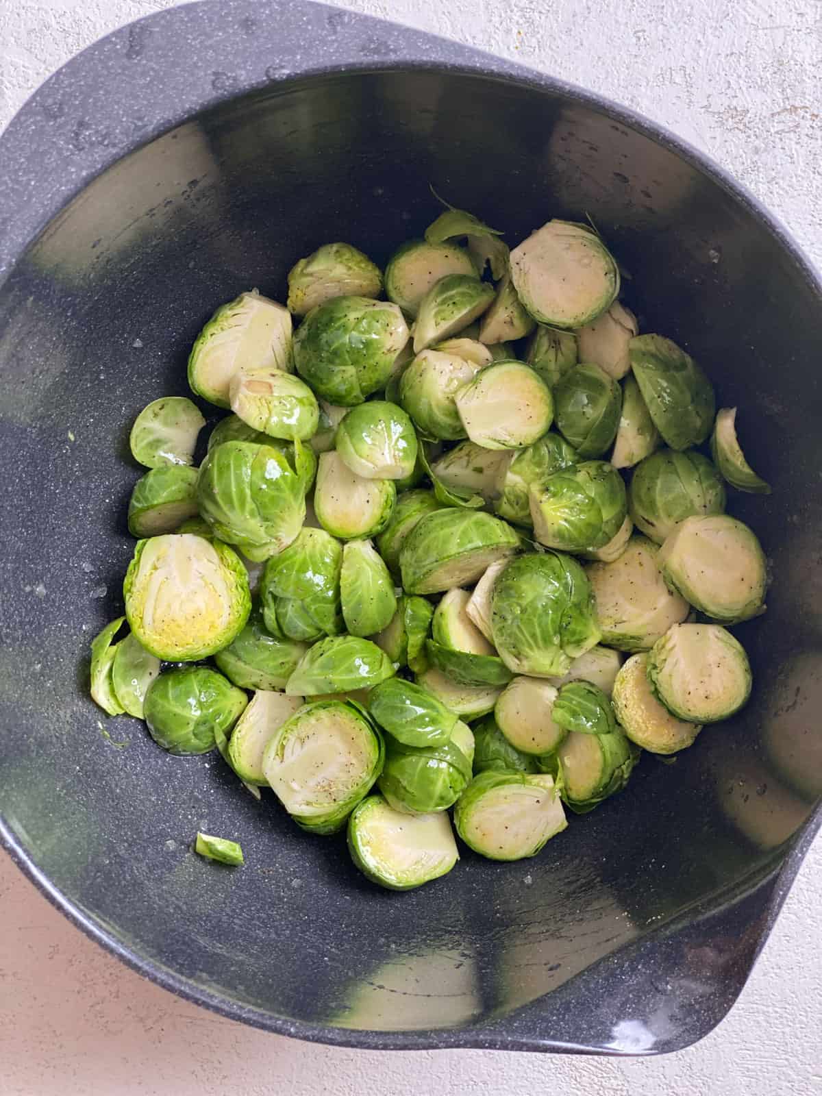 process shot of mixing brussels sprouts ingredients together in pan