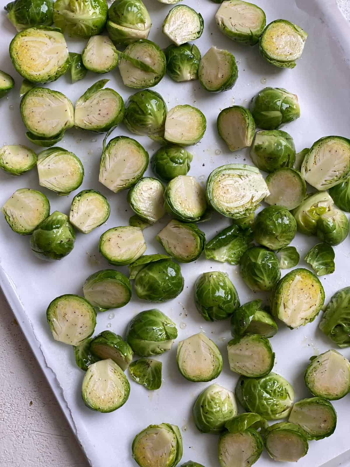 process shot of mixing brussels sprouts ingredients on baking mat