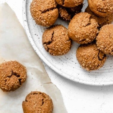 completed Soft Pumpkin Gingersnap Cookies plated on a white plate with cookies in the background