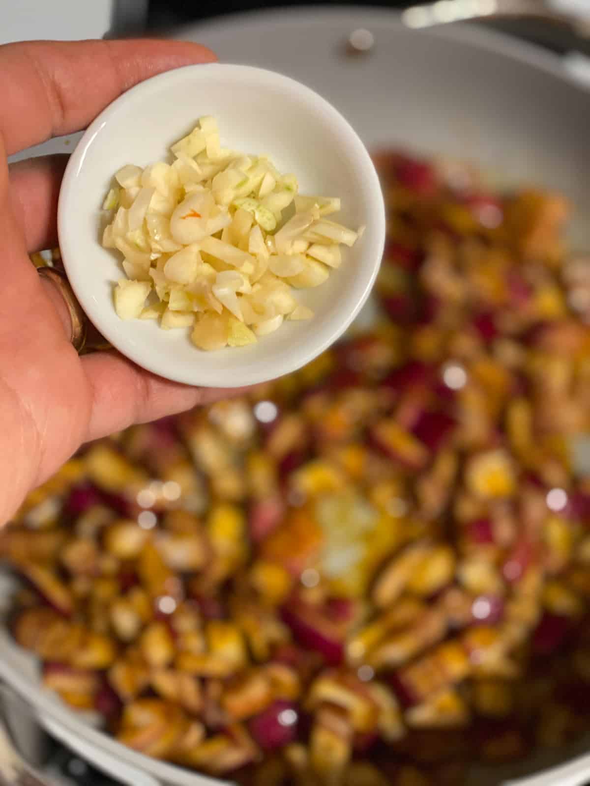 process shot of adding onions to pan