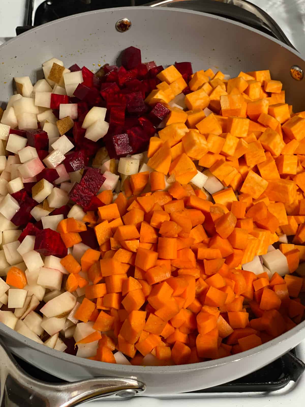 process shot of adding additional veggies to pan