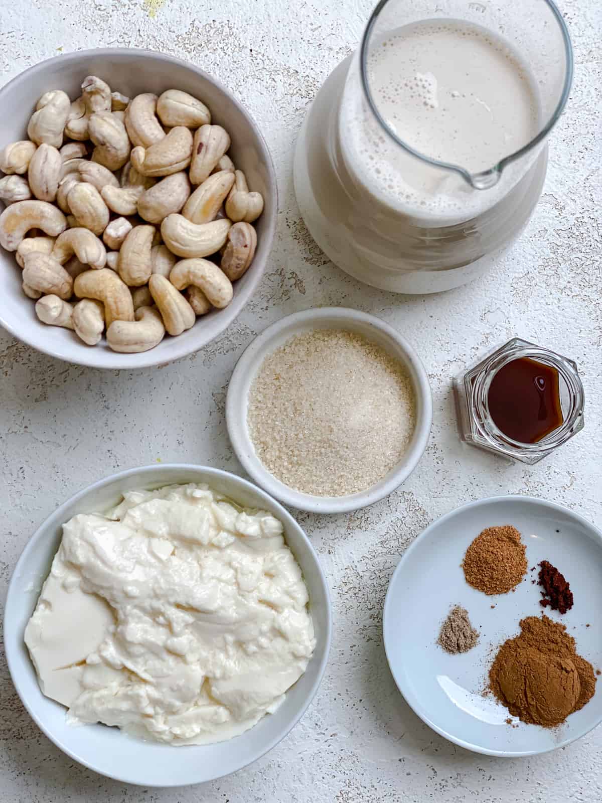 ingredients for Easy Vegan Eggnog measured out on a white surface