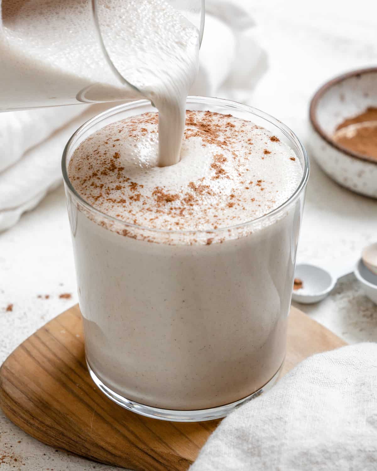 completed Easy Vegan Eggnog on a brown and white surface