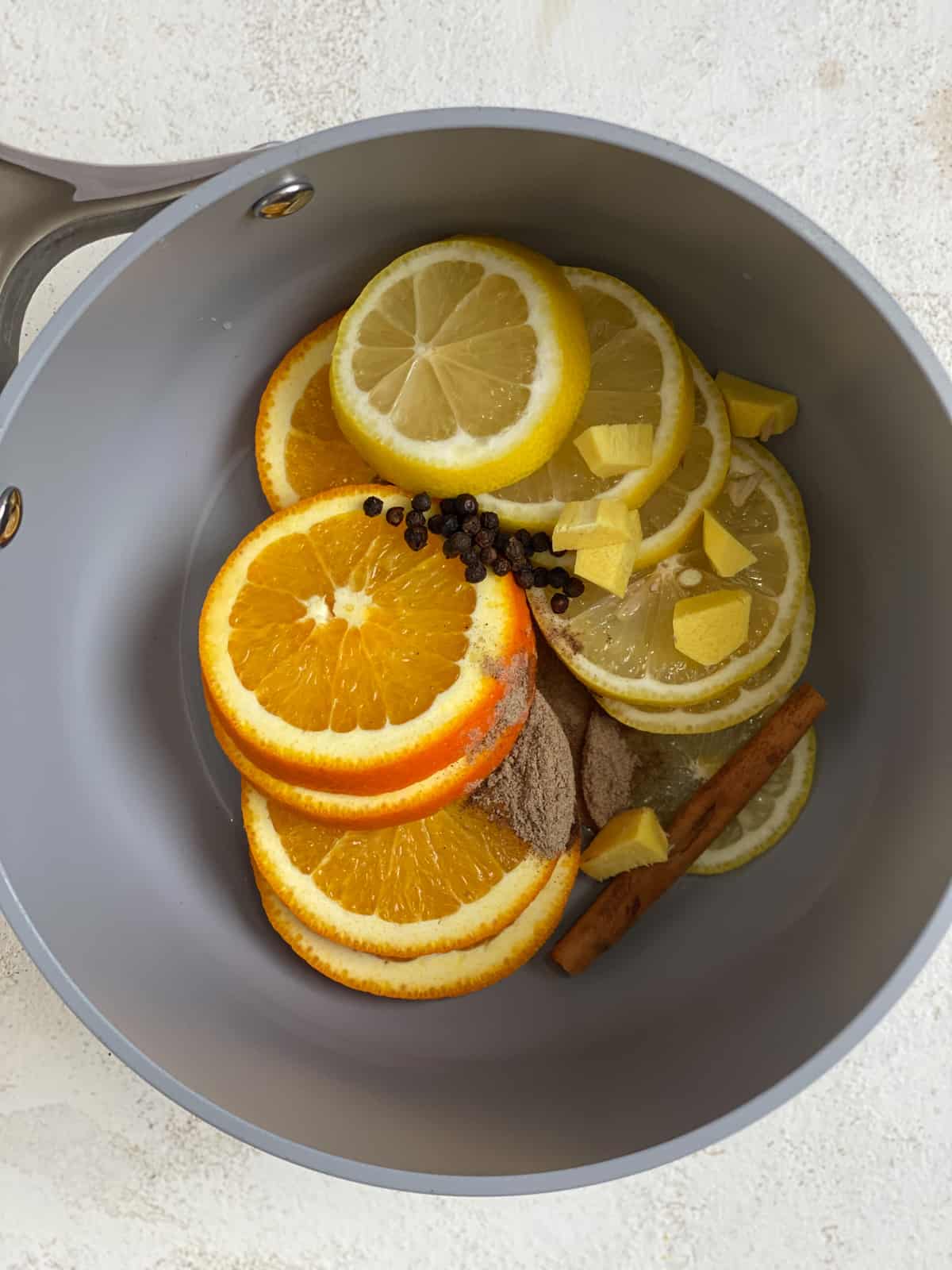 process shot of added ingredients in a pan for Lemon Cinnamon Ginger Tea