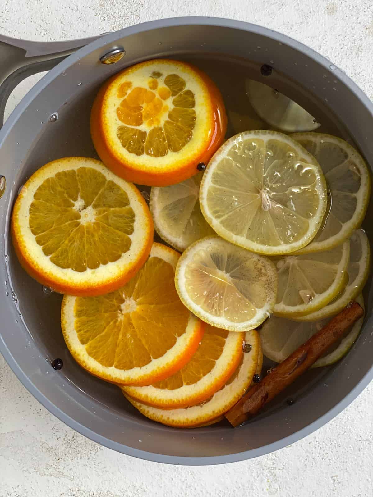 process shot of added ingredients in a pan for Lemon Cinnamon Ginger Tea