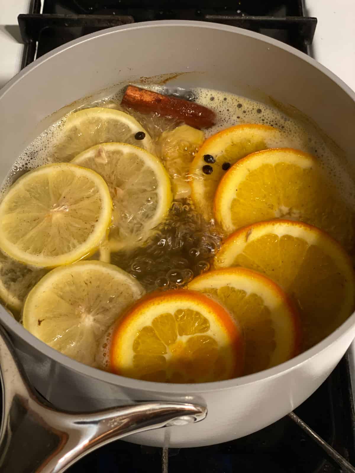 process shot showing process shot of added ingredients in a pan for Lemon Cinnamon Ginger Tea ingredients simmering in pot