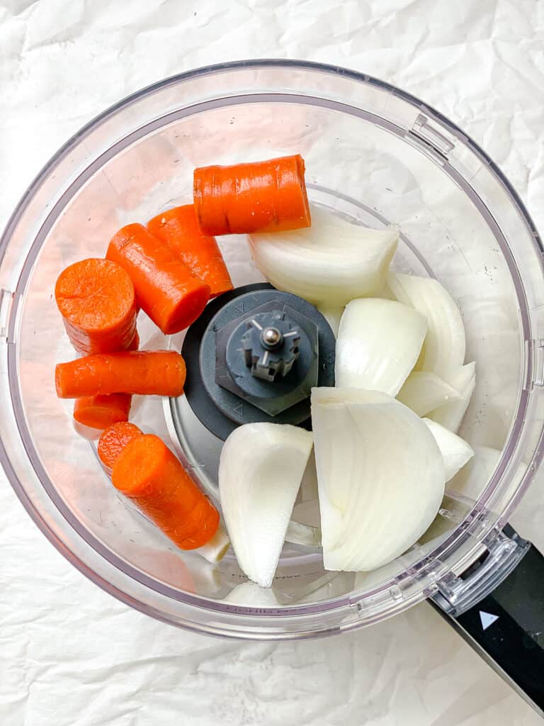 process shot of adding veggies to food processor