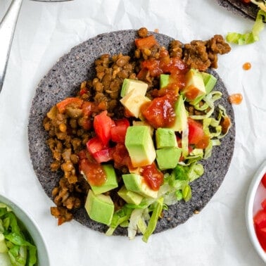 completed Lentil Tacos on a tortilla against a white background