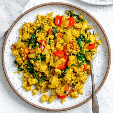 completed The Best Vegan Tofu Scramble with Veggies plated on a plate against a light background