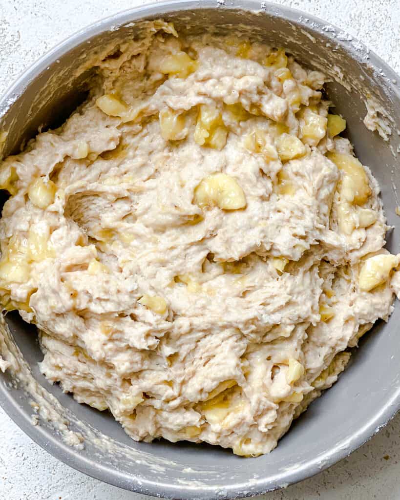 process shot of mixing ingredients together for banana bread in bowl