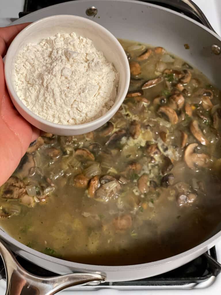 process shot of adding flour to pan