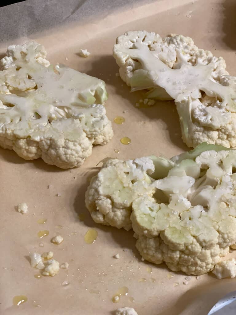 process shot of cauliflower steaks prior to being roasted