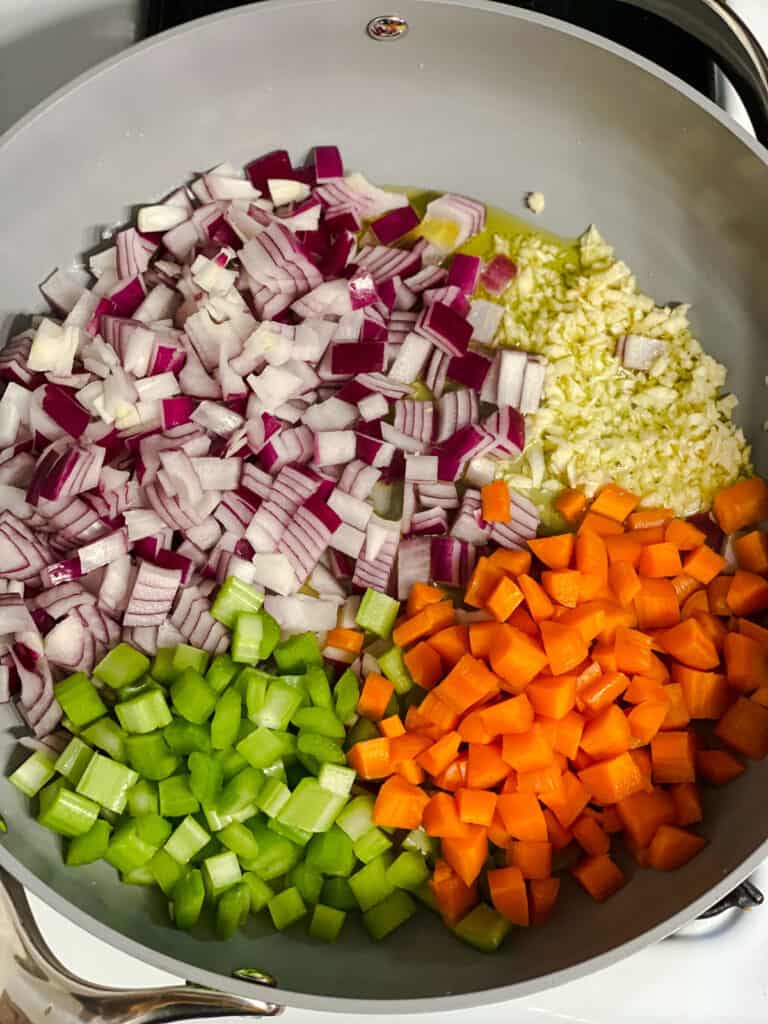 process shot of veggies added to pan