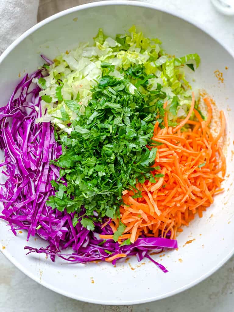 process shot of adding veggies together in a bowl