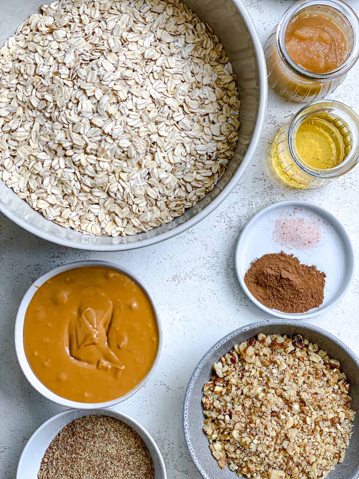 ingredients for Easy Peanut Butter Granola measured out against a white surface