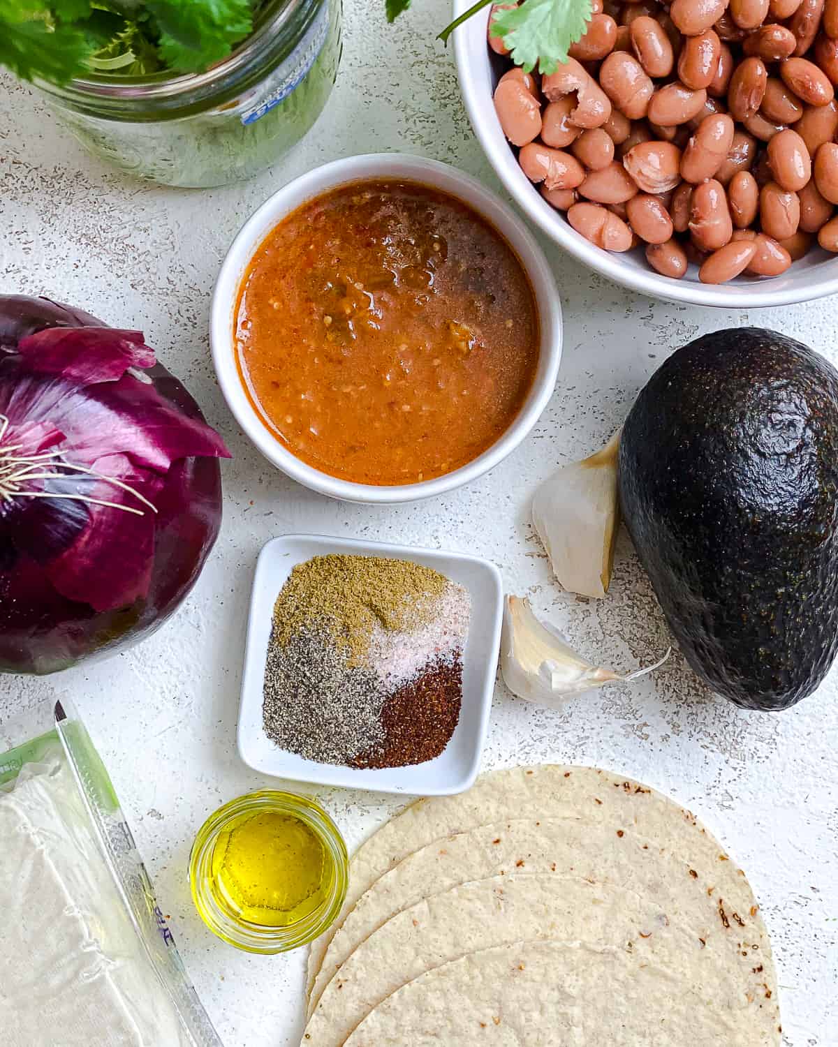 ingredients for Vegan Chilaquiles measured out against a white backgournd