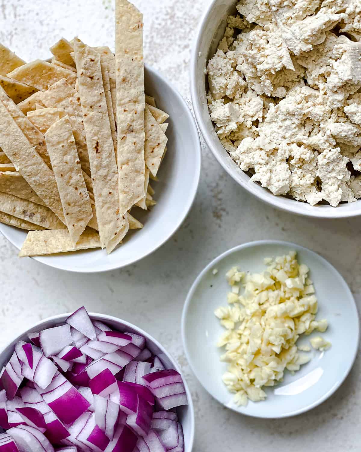 ingredients for Vegan Chilaquiles measured out against a white backgournd