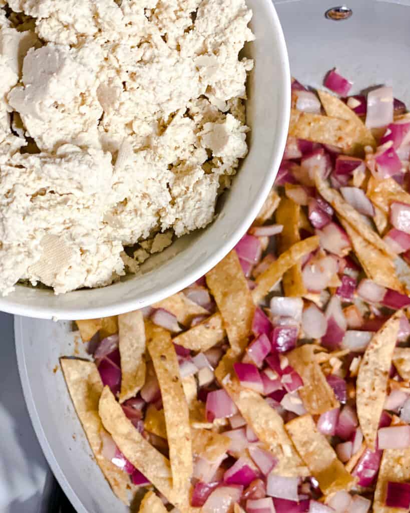 process shot of adding tofu to pan