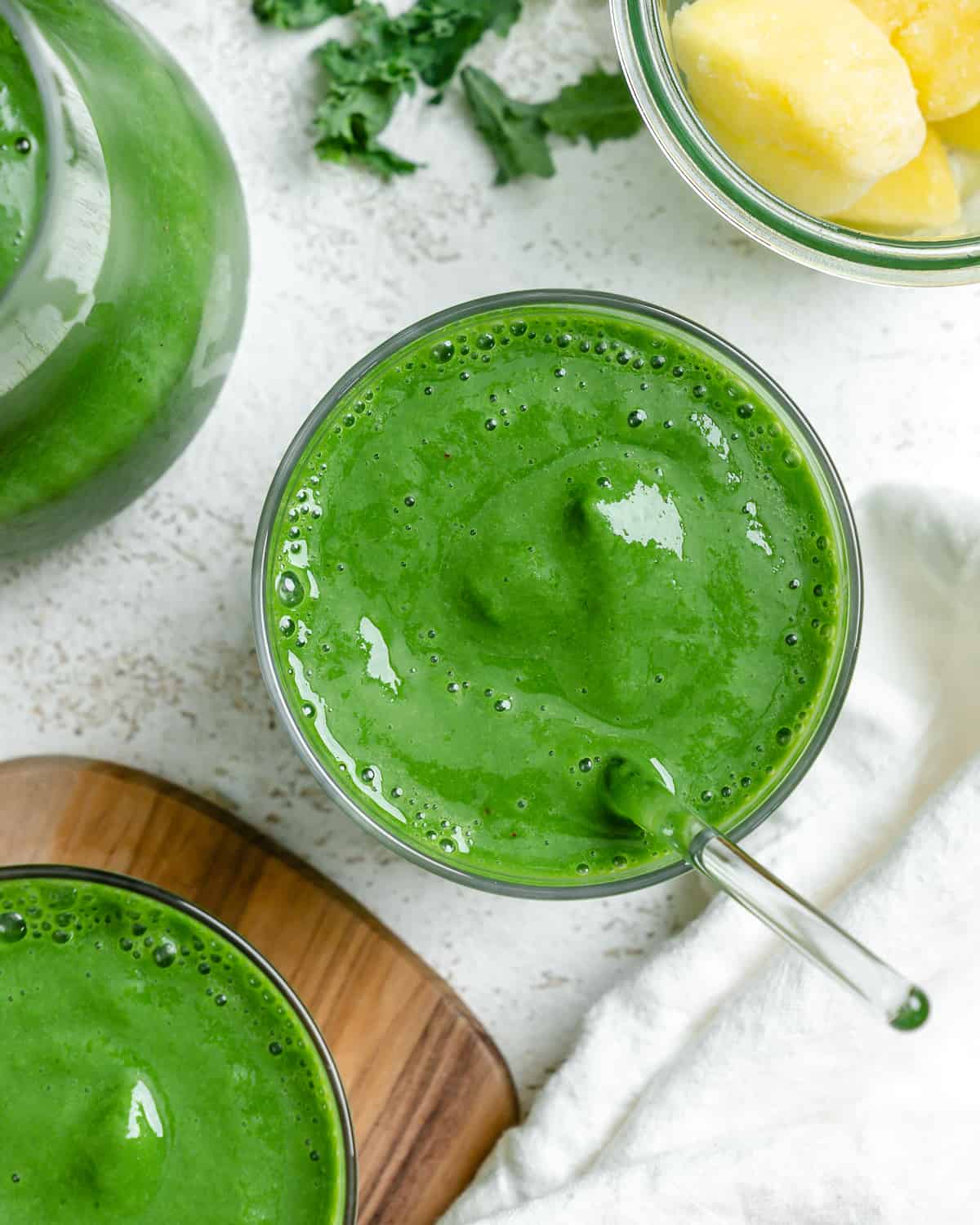 two glasses of completed Kale Pineapple Smoothie