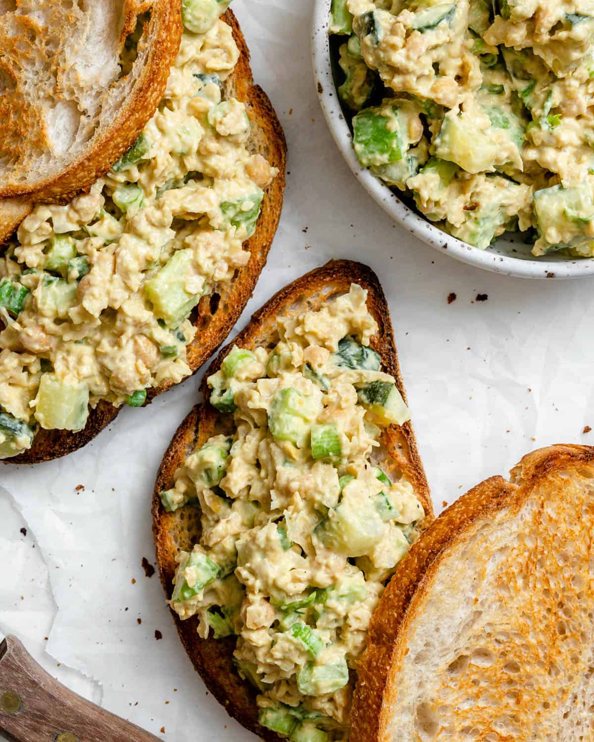 completed Plant-Based Chickpea Tuna Salad on bread against a white surface