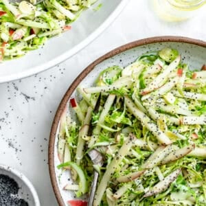 completed Shaved Brussel Sprout Slaw with Apples plated against a light surface