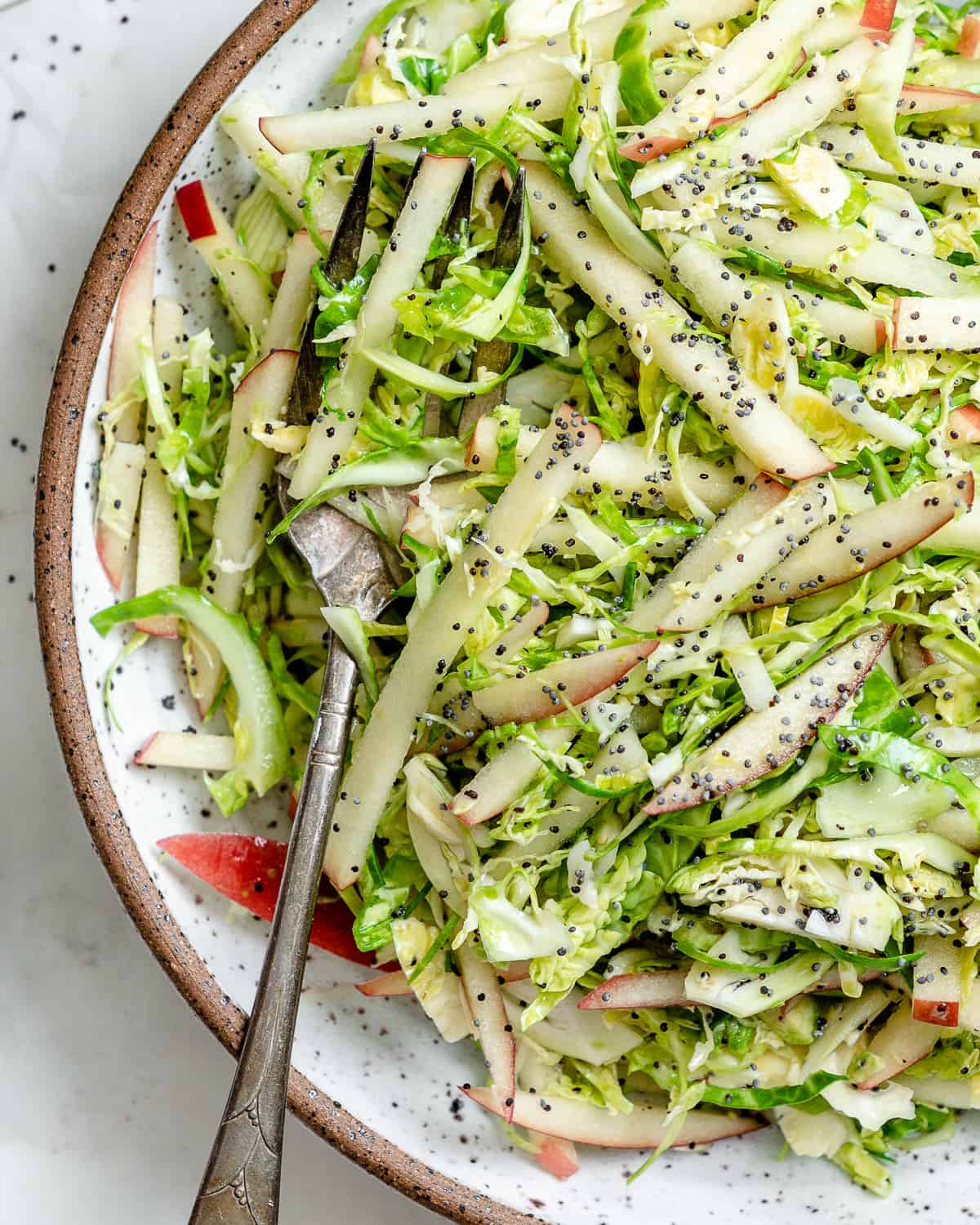 completed Shaved Brussel Sprout Slaw with Apples in a bowl