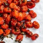 completed Easy Roasted Cherry Tomatoes against a white surface