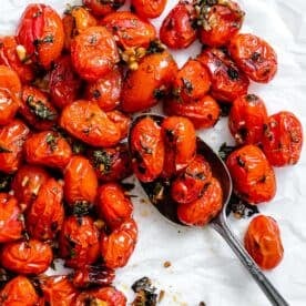 completed Easy Roasted Cherry Tomatoes against a white surface