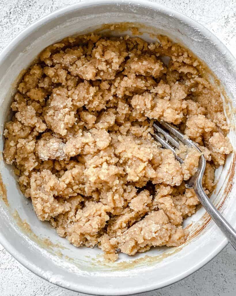 process shot of ingredients being mixed together in a white bowl