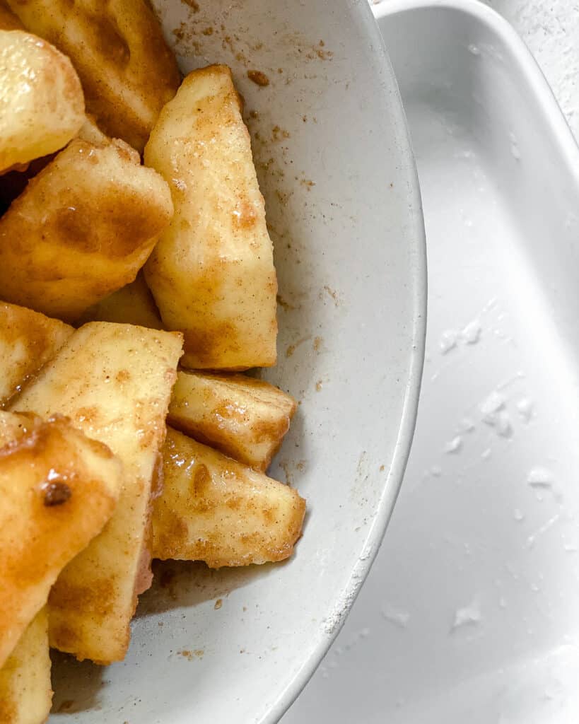 post apples being mixed with ingredients in a white bowl