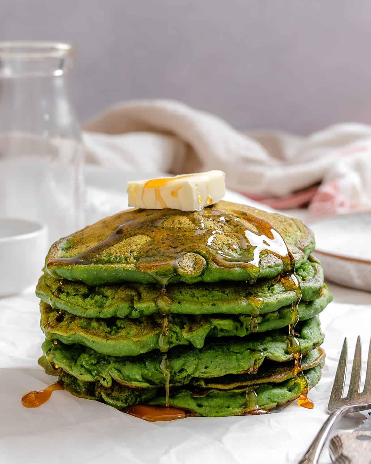 completed stack of Easy Banana Spinach Pancakes against a light surface