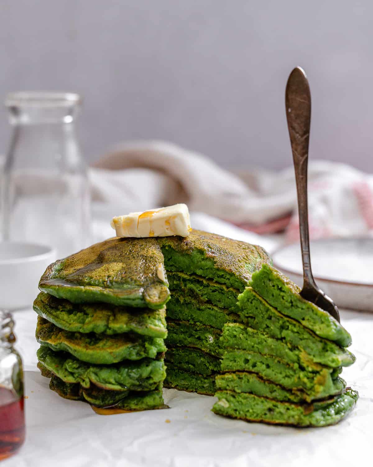 completed stack of Easy Banana Spinach Pancakes against a light surface