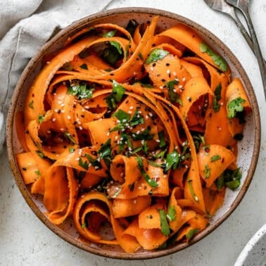 completed Raw Carrot Salad plated against a white background