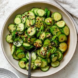 completed Spicy Asian Cucumber Salad plated on a white plate against a white background