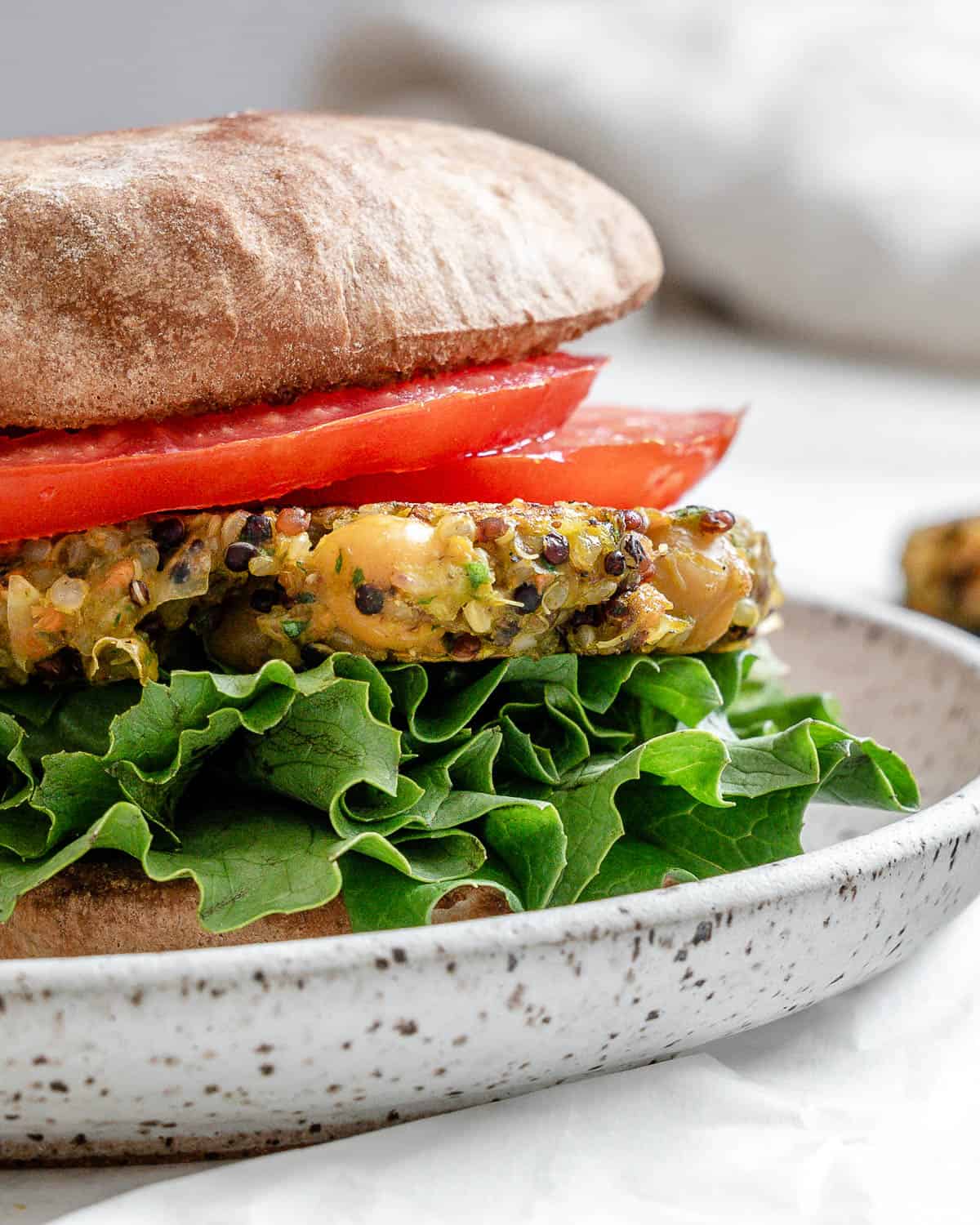 completed Quinoa Chickpea burger plated on a white surface