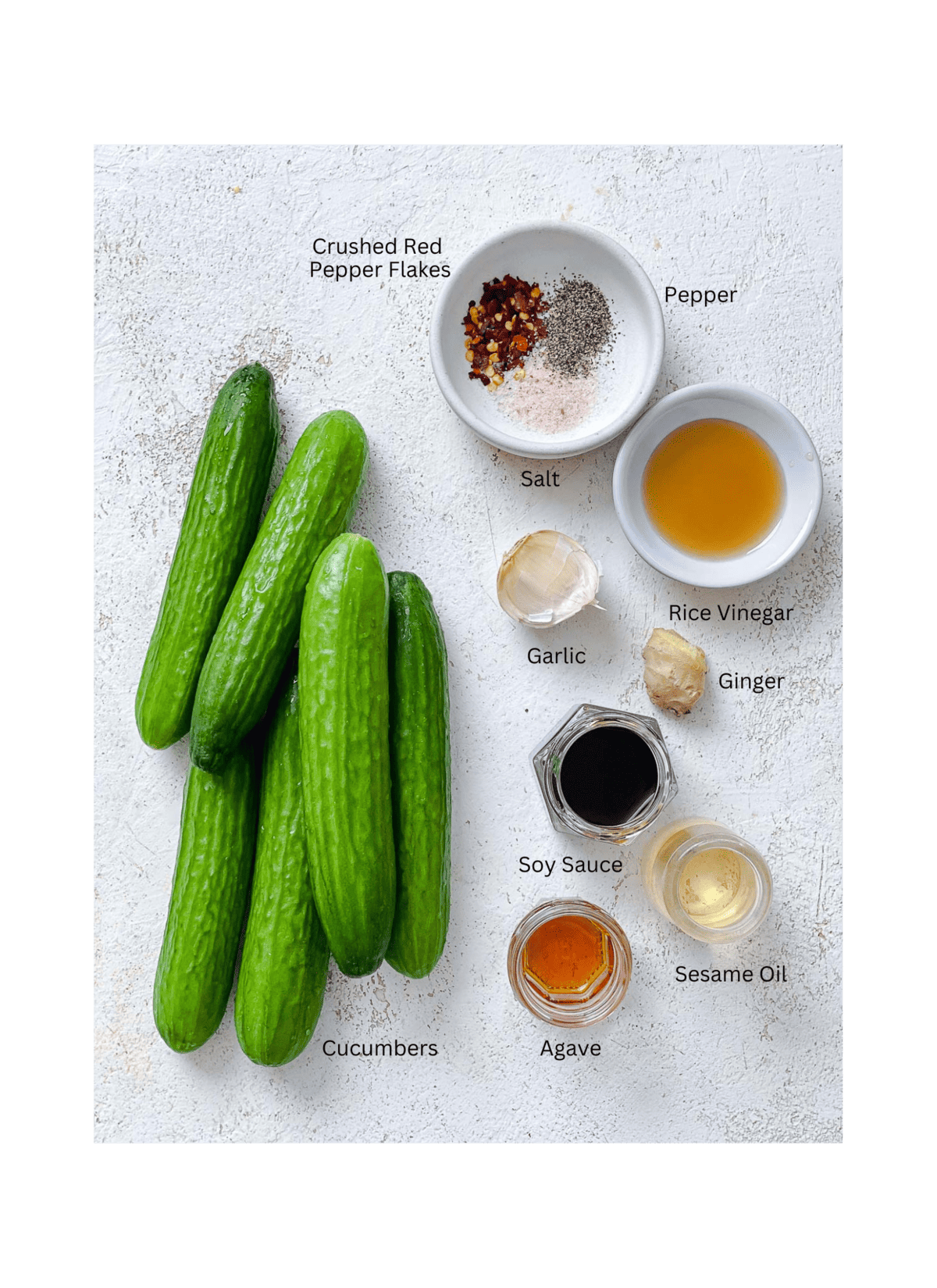 ingredients for Spicy Asian Cucumber Salad measured out against a white surface