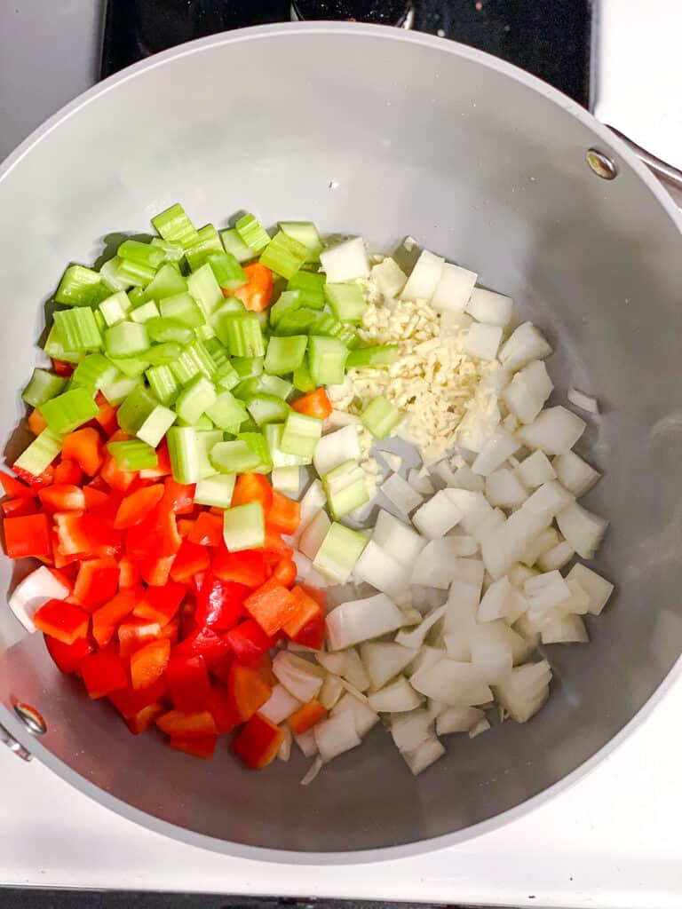 process shot showing addition of veggies in pot