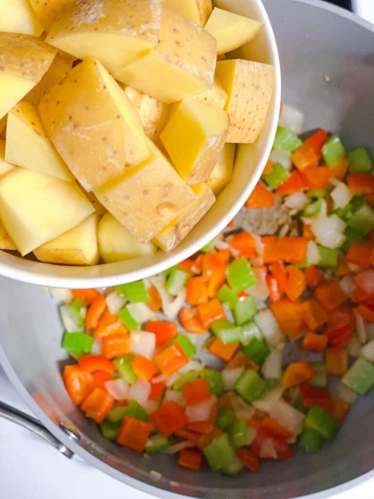 process shot of adding potatoes to pot