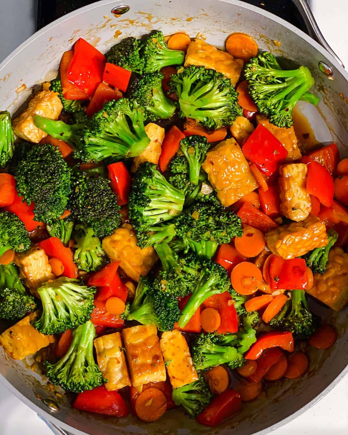 process shot of mixing ingredients together in a pan