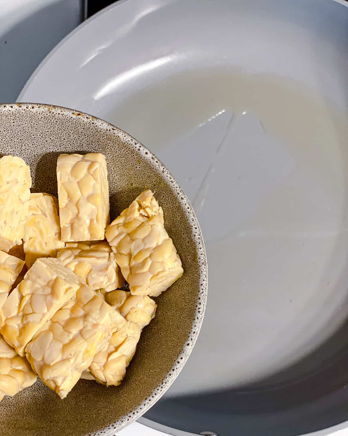 process shot of adding tempeh to pan