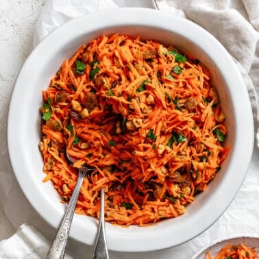 completed Healthy Carrot Raisin Salad in a. white bowl