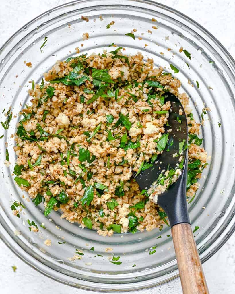 process shot of mixing ingredients together in a bowl