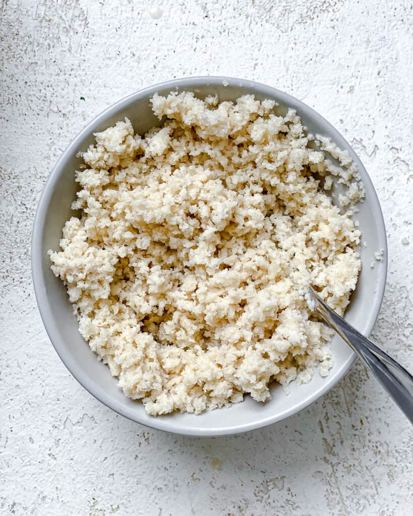 process shot of mixing breadcrumbs together in a bowl