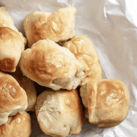 completed Easy Vegan Dinner Rolls on a white baking dish against a white background