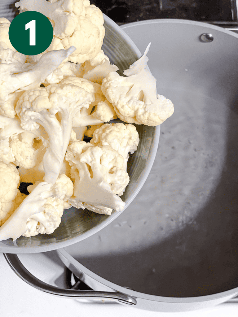 process shot of adding cauliflower to pan