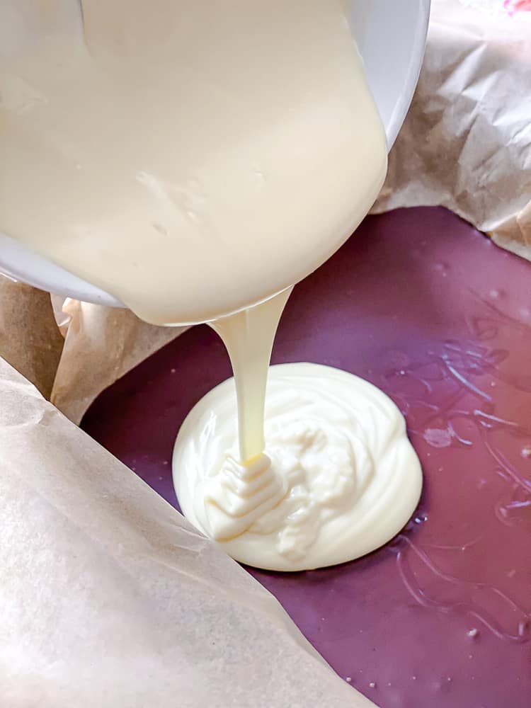 process shot showing adding vegan white chocolate in baking dish